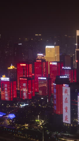 CHONGQING, CHINA - 18 MAY 2025 : Timelapse of the amazing Chongqing city skyline from a high vantage point at night in vertical