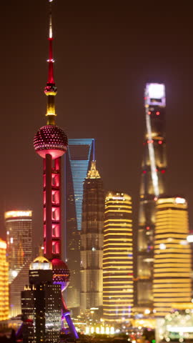 SHANGHAI, CHINA - 18 MAY 2025 : Timelapse of the Shanghai city skyline from a high vantage point at night in vertical
