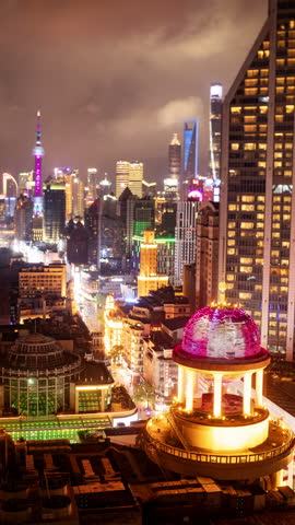 SHANGHAI, CHINA - 18 MAY 2025 : Timelapse of the Shanghai city skyline from a high vantage point at night in vertical
