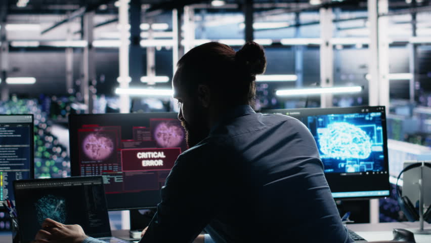 Irked data center programmer smashing desk, upset by malfunctioning gear while using AI tech. Mad server hub IT expert disgruntled by errors in glitching artificial intelligence software, camera A