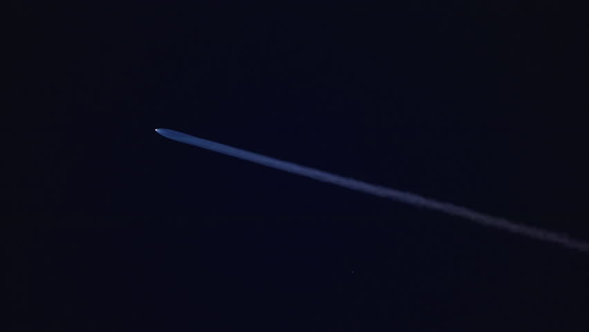 Stunning visuals of a powerful rocket launch are highlighted by a blue plume illuminating the night sky, showcasing its ascent and captivating viewers with the magnificence of this cosmic event