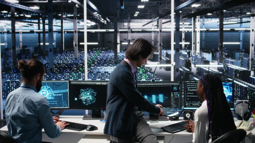 Multiracial technicians in diverse data center review AI diagnostics, analyzing neural network performance. Asian man and african american woman optimize artificial intelligence systems, camera A - Powered by Shutterstock - Get 15% off with code: PIKWIZARD15
