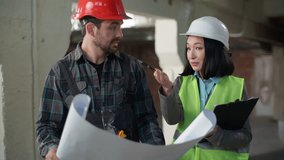 Multiethnic builders architects hardhat discussing building plan inspection Caucasian man confused engineer worker showing blueprint shrugging shoulders Asian business woman inspector talking stress - Powered by Shutterstock - Get 15% off with code: PIKWIZARD15