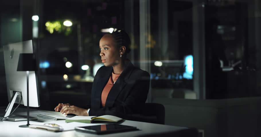 Computer, night or black woman typing for trading on stock market or cryptocurrency in late shift. Business, financial trader or analyst in overtime for economic price, investment growth or finance