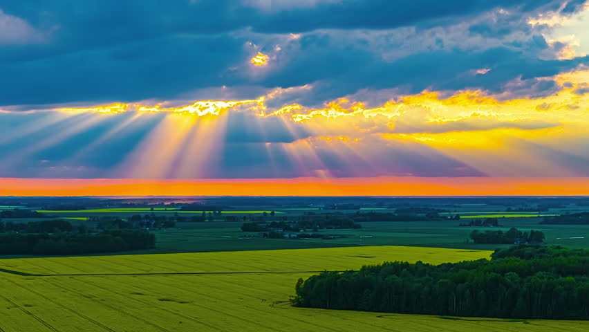 Sunrays Through The Clouds Over The Fields In The Countryside. - timelapse shot