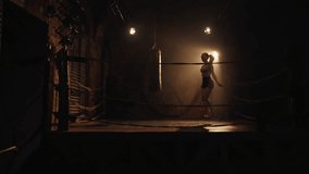 Athletic woman skipping rope in gym, vertical video, motivated sportswoman training alone in night. Healthy lifestyle and physical exercises for stay slender and beautiful, alluring female silhouette - Powered by Shutterstock - Get 15% off with code: PIKWIZARD15