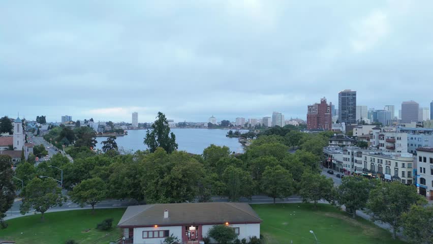 Early morning light casts soft tones across Lake Merritt, framed by parks and downtown architecture.