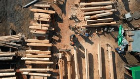 Aerial view of wooden house frame construction captured. Building processing with workers maneuvering logs. - Powered by Shutterstock - Get 15% off with code: PIKWIZARD15