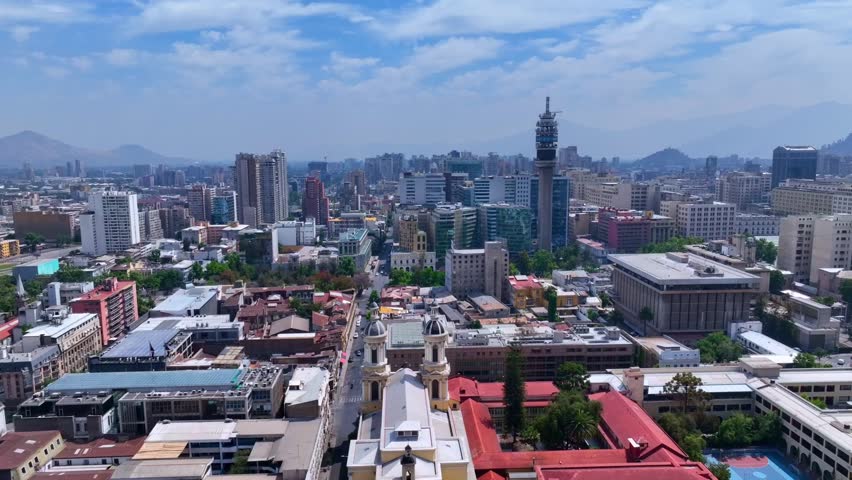 Forward Drone Shot Moving Toward Entel Tower in Central Santiago with Church and City Buildings in Foreground