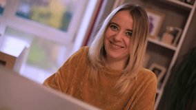 Close-up of a smiling woman in a cozy home setting, wearing a warm sweater and looking at the camera. Soft light and casual atmosphere convey happiness and comfort. - Powered by Shutterstock - Get 15% off with code: PIKWIZARD15