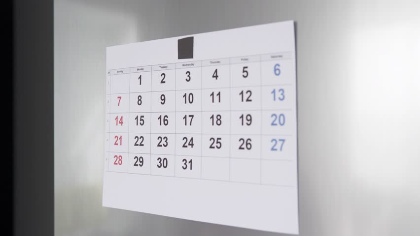 A person marks an important date on the calendar.
