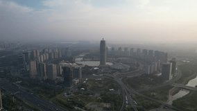Zhengzhou, China, aerial video of the CBD building complex of Zhengdong New District in the summer morning fog, with the International Convention and Exhibition Center visible. - Powered by Shutterstock - Get 15% off with code: PIKWIZARD15