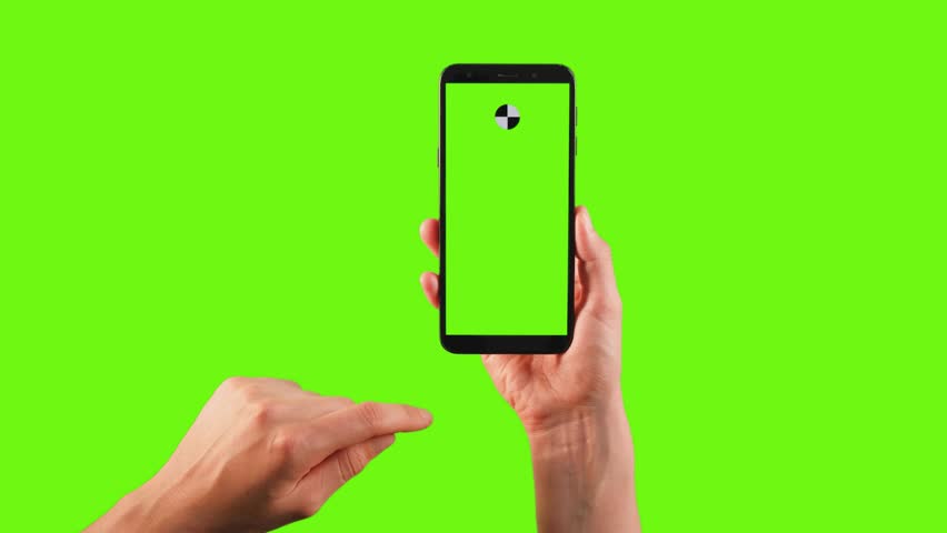 man hand tapping chroma key smartphone in company office closeup. woman turning on online application on green screen background cellphone. browsing social media at mockup mobile phone. Business