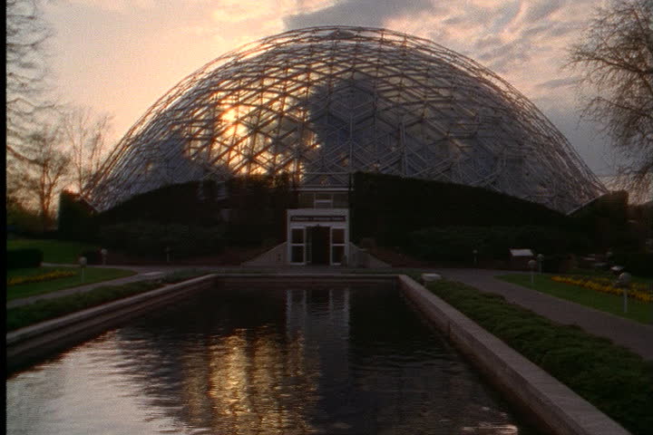 ST. LOUIS - CIRCA MARCH 2000: Exterior Climatron dome with pink sunset light shining through onto reflecting pool.