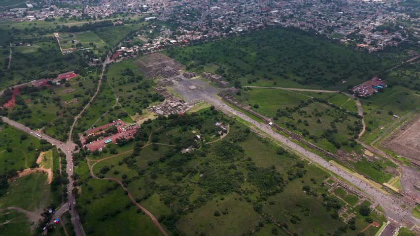 Aerial view of a green valley featuring Pyramids of Sun and Moon in Mexico