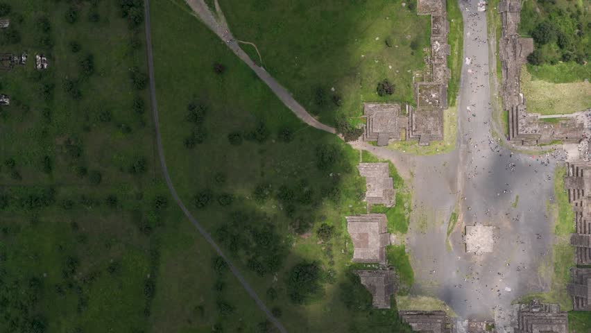 Aerial bird's-eye shot showing light and shadow playing over Teotihuacan, Mexico