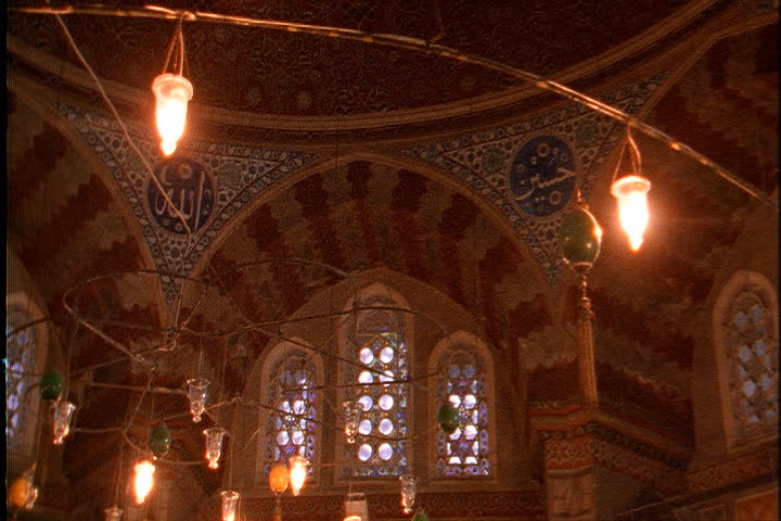 ISTANBUL - CIRCA NOVEMBER 1999: Tilt down from ornate domed ceiling to tombs of Suleymaniye and his family.