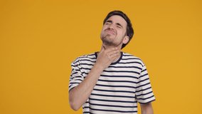 Young Man Has Sore. Sick Guy With Swollen Throat On Yellow Studio. Angina, pain - Powered by Shutterstock - Get 15% off with code: PIKWIZARD15