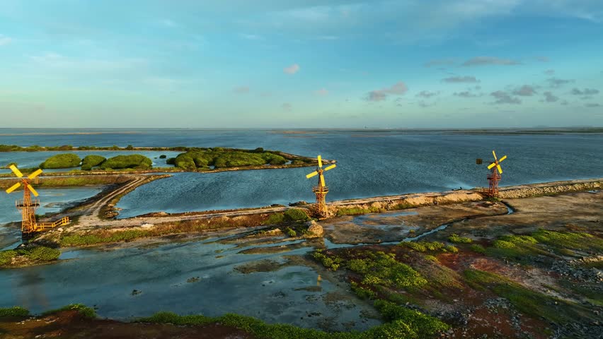 Aerial view of the vibrant windmills contrasting the vast ocean, and the lush greenery in Kralendijk, Bonaire, Caribbean Netherlands.
