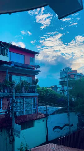 Early morning clouds drift over Kathmandu Valley, Nepal, painting the sky in soft hues. This tranquil footage captures serene layers of mist, hills, and peaceful atmospheres in motion. 15 JUNE,2025