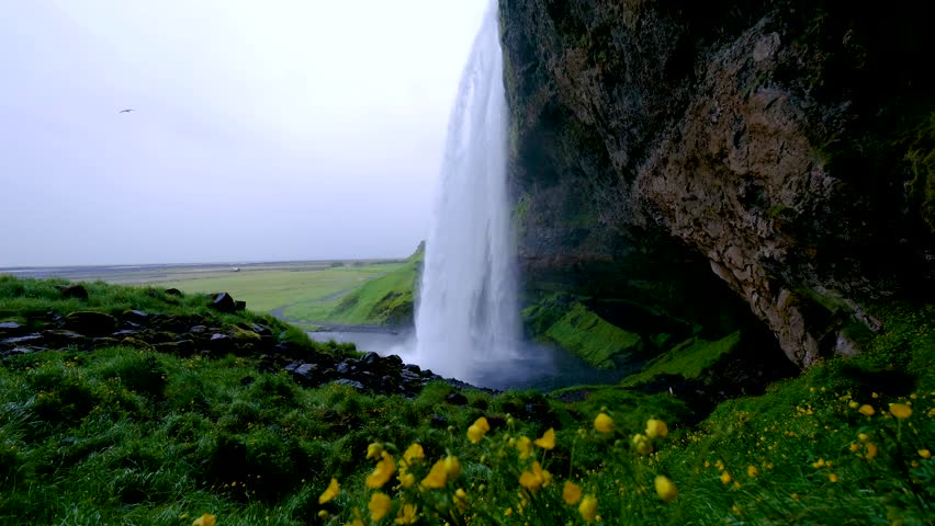 Seljalandsfoss waterfall in summer in Iceland with a moody sky