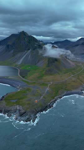 Experience the breathtaking beauty of Icelands rugged landscape where majestic mountains meet the crashing waves of the sea.