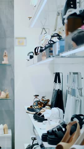 Shoe store. buying new shoes. Good looking lady customer looking to the shoes in a shoe shop, want to try some. Young woman choosing new footwear in a shoe store or Shopping mall. shopping. Purchases.