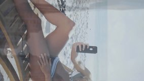 Animation of financial data processing over woman on beach. Global holiday, business, finance, computing, connections and data processing concept digitally generated video. - Powered by Shutterstock - Get 15% off with code: PIKWIZARD15