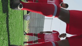 Animation of social media icons over team of diverse male soccer players training on sports field. Social media networking and sports fitness concept - Powered by Shutterstock - Get 15% off with code: PIKWIZARD15