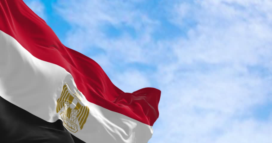 Egypt national flag waving on a clear day. Horizontal red, white and black bands. Egyptian eagle emblem centered in white band. Seamless 3d render animation. Slow motion loop. Selective focus