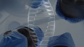 Animation of dna strand spinning over diverse suergeons. Global medicine, connections, computing and data processing concept digitally generated video. - Powered by Shutterstock - Get 15% off with code: PIKWIZARD15