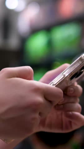Rack focus shot of smiling teenage girl listening music while using mobile phone at home