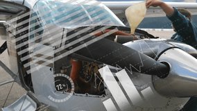 Man lifting engine cowling on tarmac, inserting funnel and pouring oil for pre-flight engine check. Aviation, maintenance, industry, outdoors, technical, service, professional - Powered by Shutterstock - Get 15% off with code: PIKWIZARD15