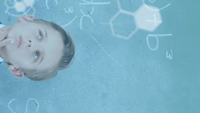 Animation of dna strand diagrams and data processing over caucasian schoolboy at chalkboard. Education, childhood, school and learning concept digitally generated video. - Powered by Shutterstock - Get 15% off with code: PIKWIZARD15