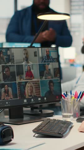 Vertical Video Employees sharing ideas on a web video conference call at the workstation, discussing about project briefing with charts and reports. Business associates attending online meeting event