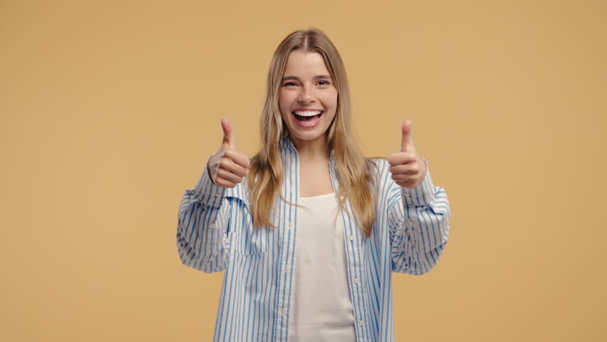 Happy woman gives thumbs up LIKE gesture with excitement and expressive approval