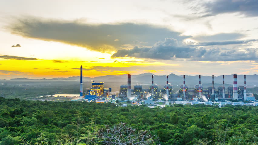 Timelapse 4K video, aerial view of a coal-fired power plant at sunset, with smoke from cooling, natural power, air environment, and industrial concept.
