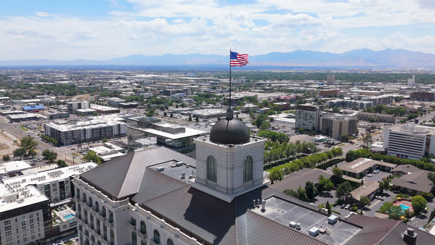 Aerial photographs capturing the skyline of Salt Lake City beautifully showcase its vibrant urban landscape and iconic architectural structures set against the majestic backdrop of towering mountains