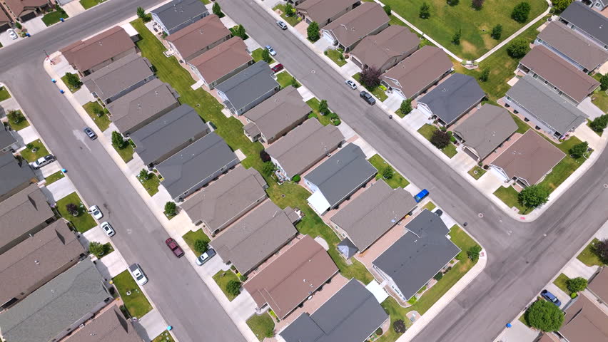 Aerial footage showcases a vibrant American suburban neighborhood with charming homes, well maintained roads, and a community tennis court, offering leisure and social opportunities for residents