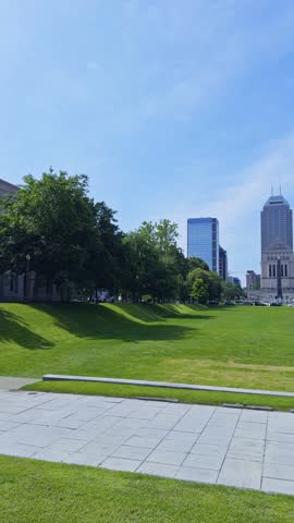 Vertical establishing pan of American Legion Mall on bright summer day in Indianapolis