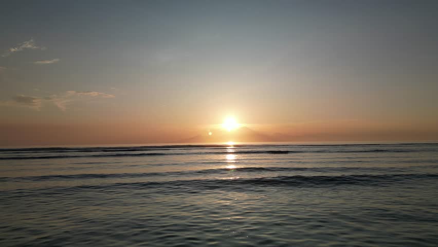 Drone flying forward over the ocean at sunset – cinematic, peaceful scene perfect for inspirational content, reels, or travel footage.