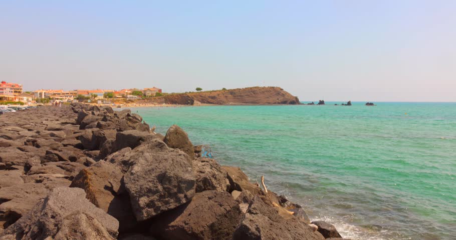 Rocky Coastline Of Plage La Plagette In Cap d'Agde, France. - wide shot