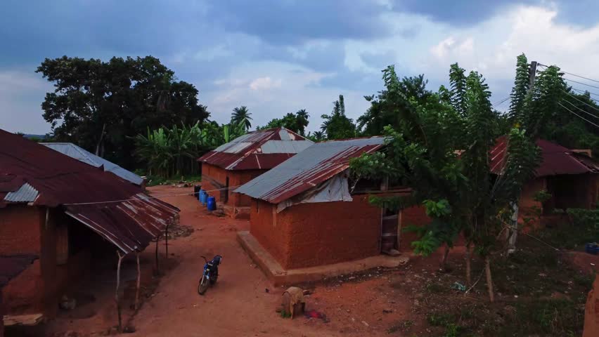 Aerial towards a rundown home in a small Nigerian quiet village. Local palmoil producing village in ibadan, Africa.