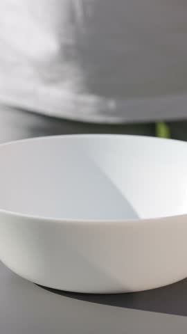 chef put in bowl sliced fresh green romaine lettuce leaves to prepare a healthy salad. outdoor cooking, food closeup