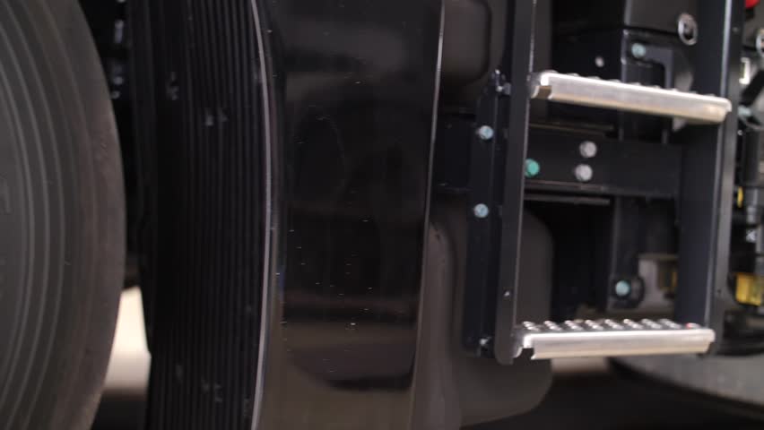 Various components of a semi-truck, including ladder, fuel tank, chassis, steps, and wheels, highlighting their construction and condition. New transport for cargo transportation, logistics concept.