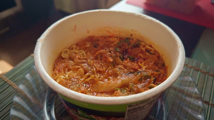 freshly prepared instant ramen noodles in disposable cup. Asian noodle cuisine. fast meal solutions and traditional food. instant ramen. Noodle soup with dry seasoning. Asian quick meal instant noodle