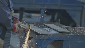 Worker Grinding Metal Plate. Steel structure metalworking shop. A worker grinds a metal plate or sheet with a hand grinder. Worker preparation steel plate by hand grinding machine. - Powered by Shutterstock - Get 15% off with code: PIKWIZARD15