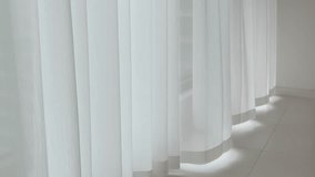 White sheer curtains gently sway as wind blows through, creating a soft, tranquil home ambiance.	 - Powered by Shutterstock - Get 15% off with code: PIKWIZARD15