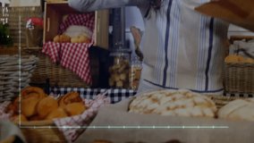 Female vendor reaching for bag and unfolding then placing pastries with tongs for sale in bakery. Artisanal, warm, rustic, bakery, handcrafted, cozy, domestic - Powered by Shutterstock - Get 15% off with code: PIKWIZARD15
