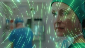 Green-scrubbed surgeon turning head after green medical overlay rippling and highlighting smile. Medical, healthcare, innovation, digital, professional, sterile, teamwork - Powered by Shutterstock - Get 15% off with code: PIKWIZARD15